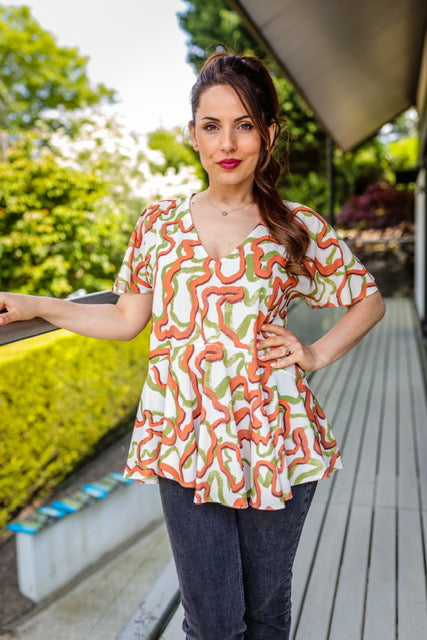 Abi Angel Sleeve Summer Top With Ruffle Hem In Green And Orange Print Love