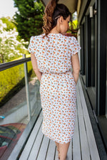 Załaduj obraz do przeglądarki galerii, Paige Summer Midi Wrap Dress In White With Orange Ditsy Floral Print
