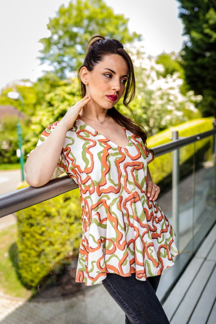Abi Angel Sleeve Summer Top With Ruffle Hem In Green And Orange Print